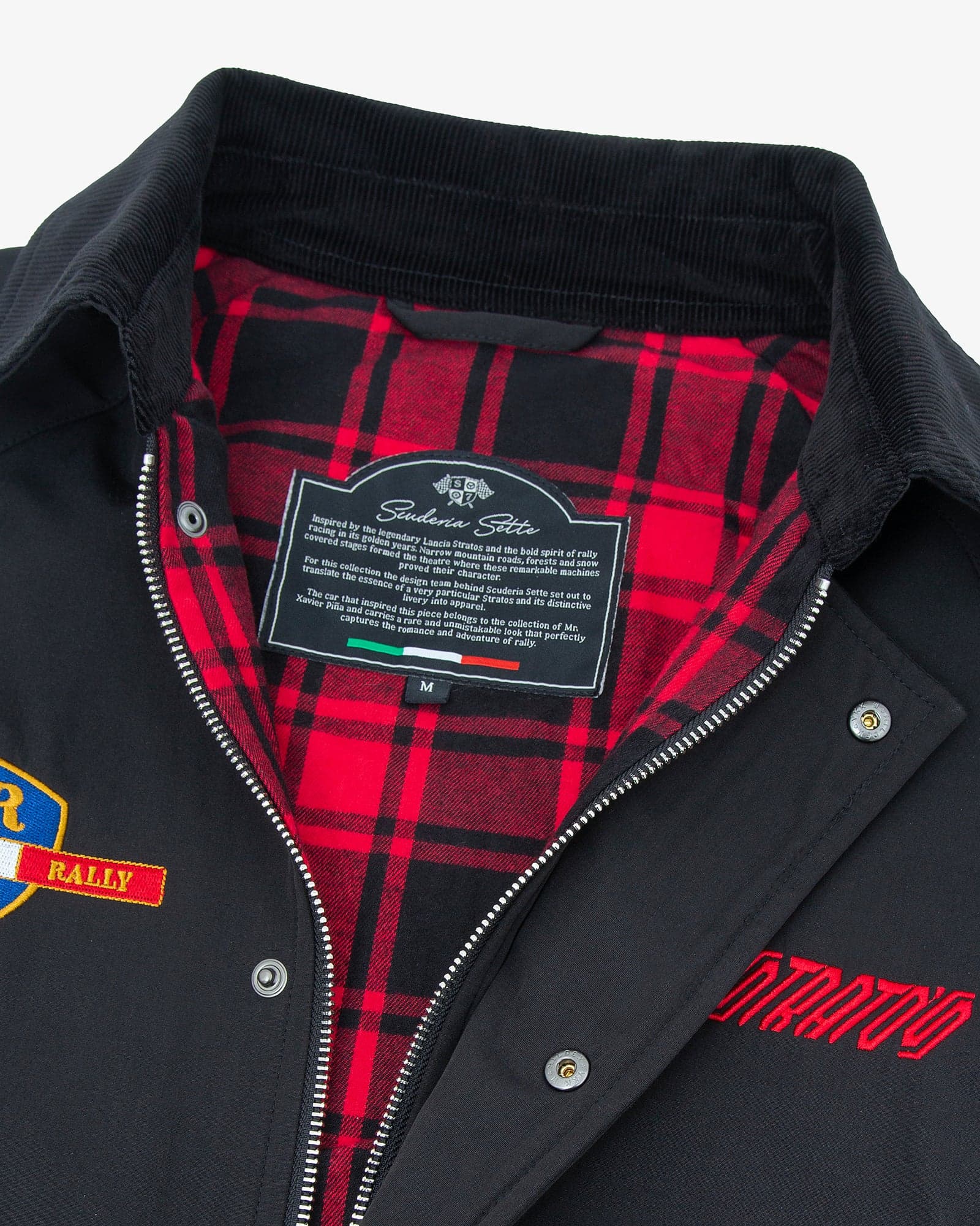 Stratos jacket open at the collar, showing the red and black check lining, the woven label and the Stratos embroidery on the chest